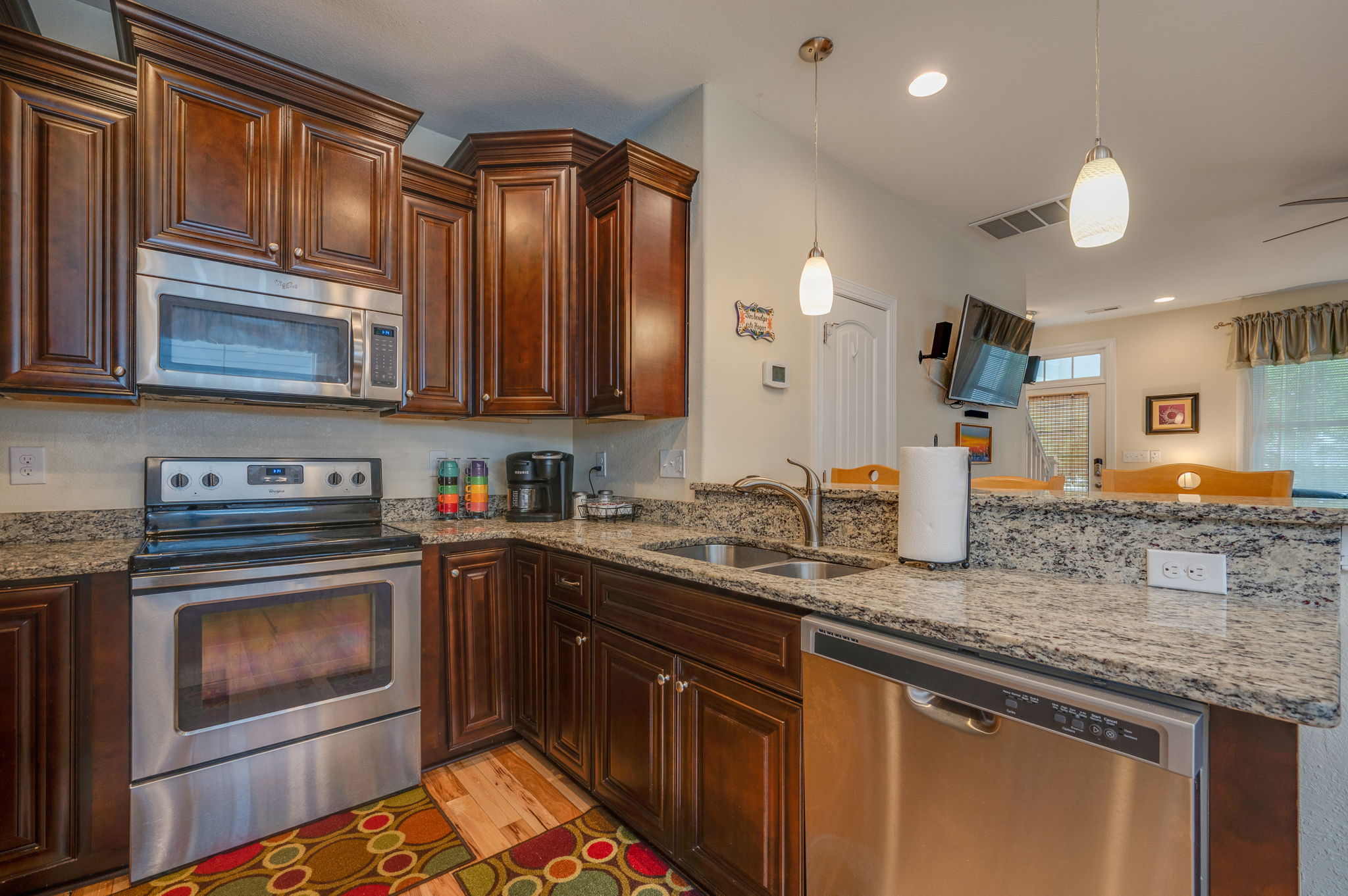 A different angle of the kitchen, showcasing a large stainless steel refrigerator and ample counter space.