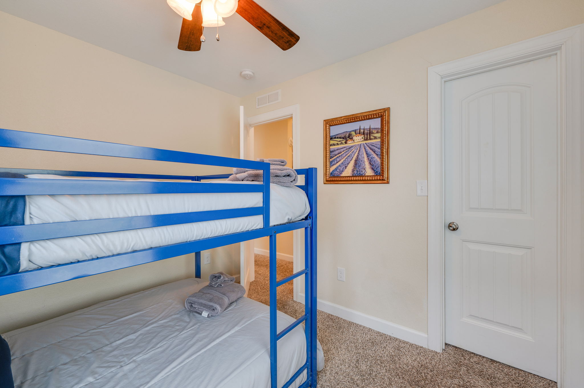 Kid-friendly bedroom featuring blue bunk beds and a cozy atmosphere.