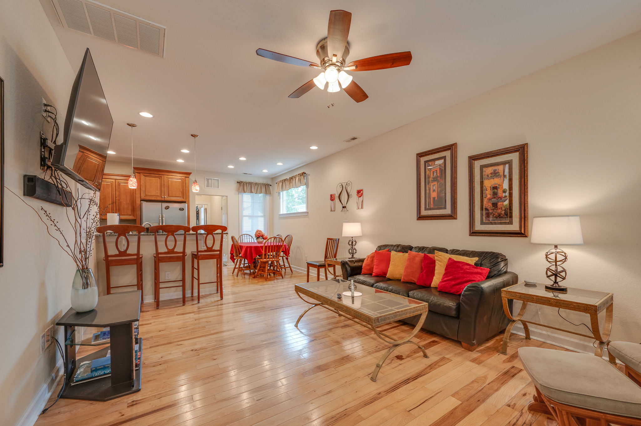 Spacious open-concept living room with cozy seating and warm lighting.