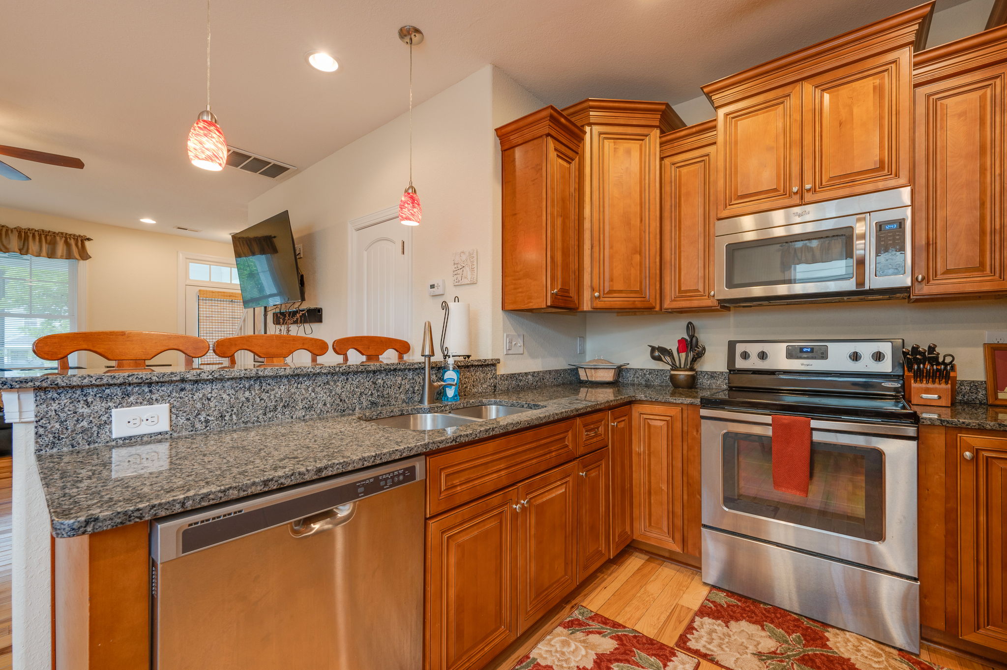 Well-equipped kitchen featuring stainless steel appliances and ample counter space.