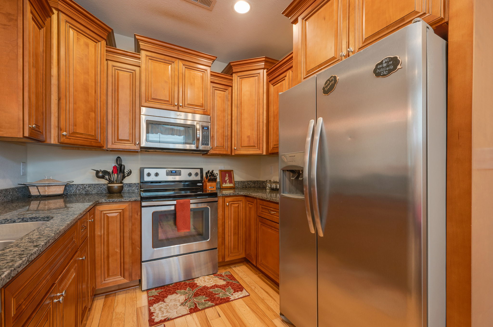 Warm and inviting kitchen with a modern touch and rich wood cabinetry.