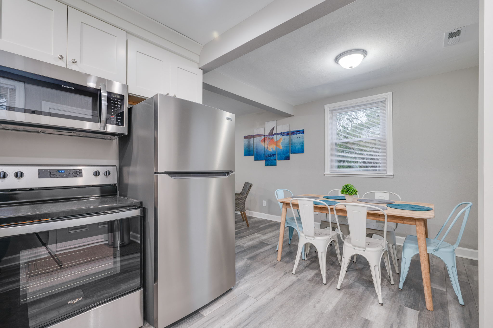 Open kitchen and dining area with stylish furnishings and modern appliances.