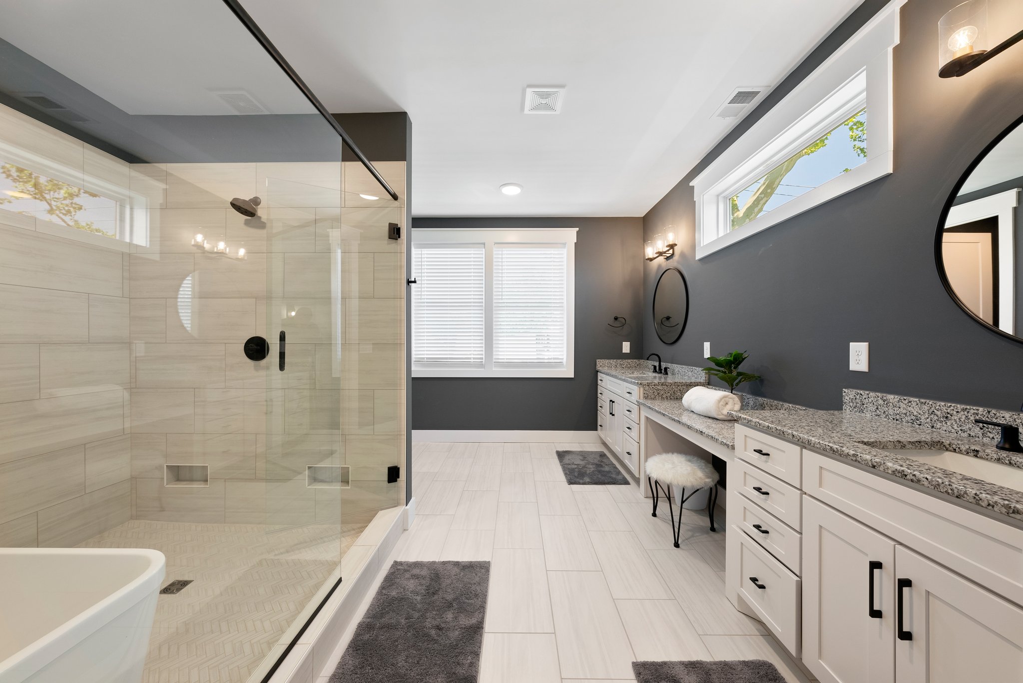 Luxurious bathroom with large glass shower, soaking tub, and double vanity