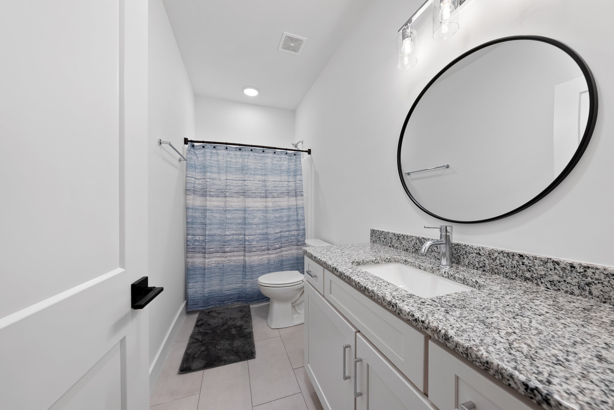 Game Room Bathroom with Granite Countertop and Modern Finishes