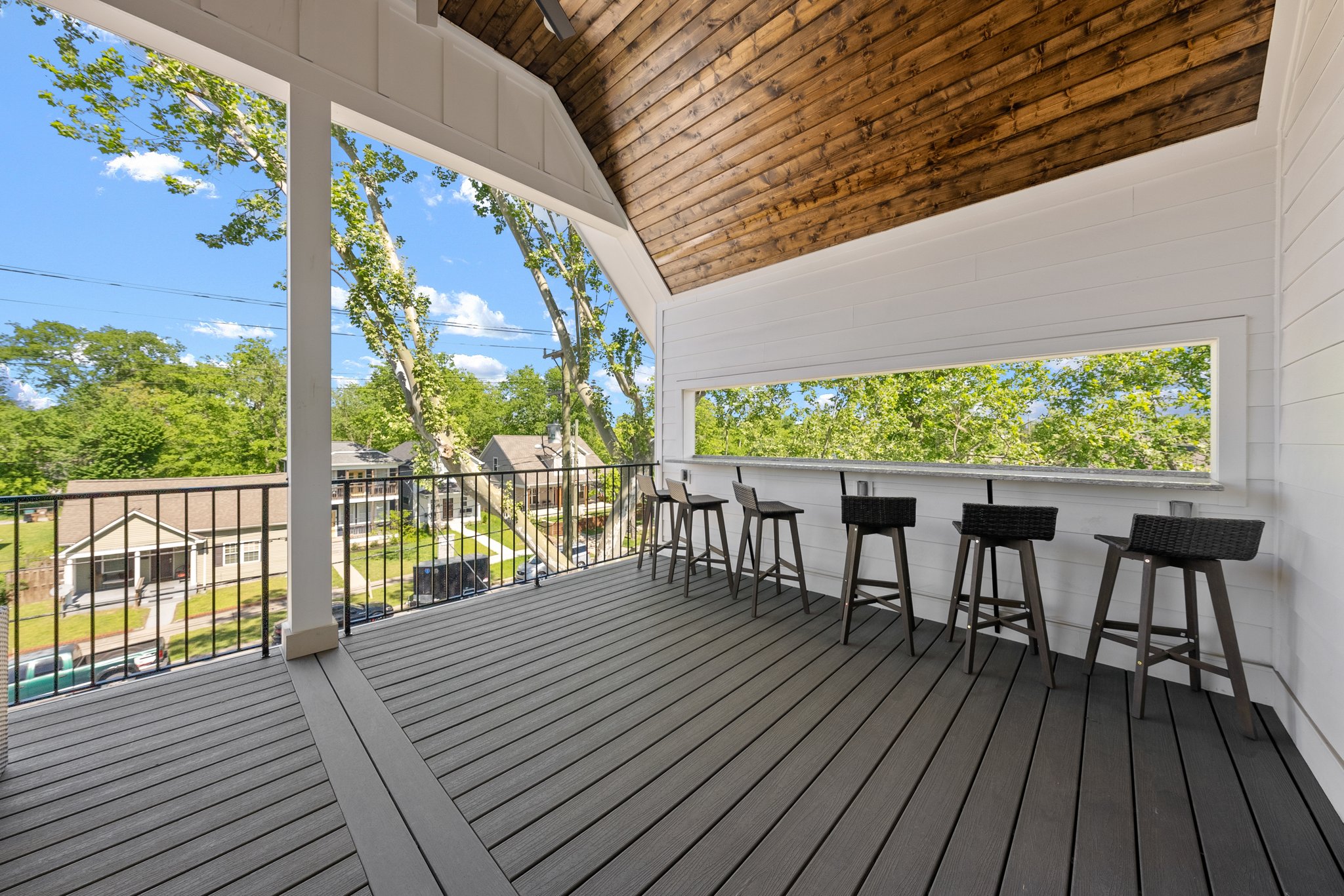 Spacious Covered Balcony with Bar Seating and Scenic View