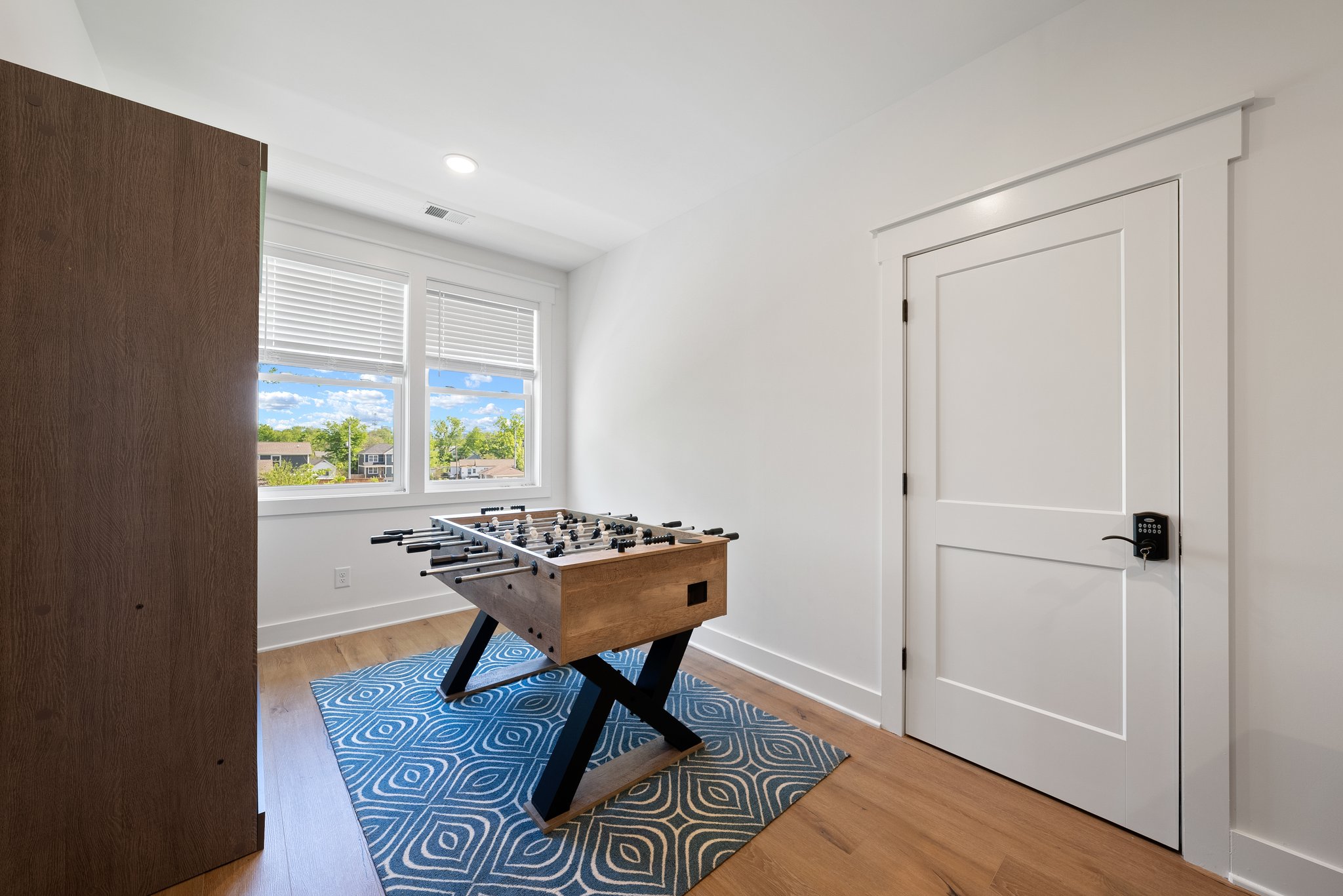 Game Room with Foosball Table and Blue Rug