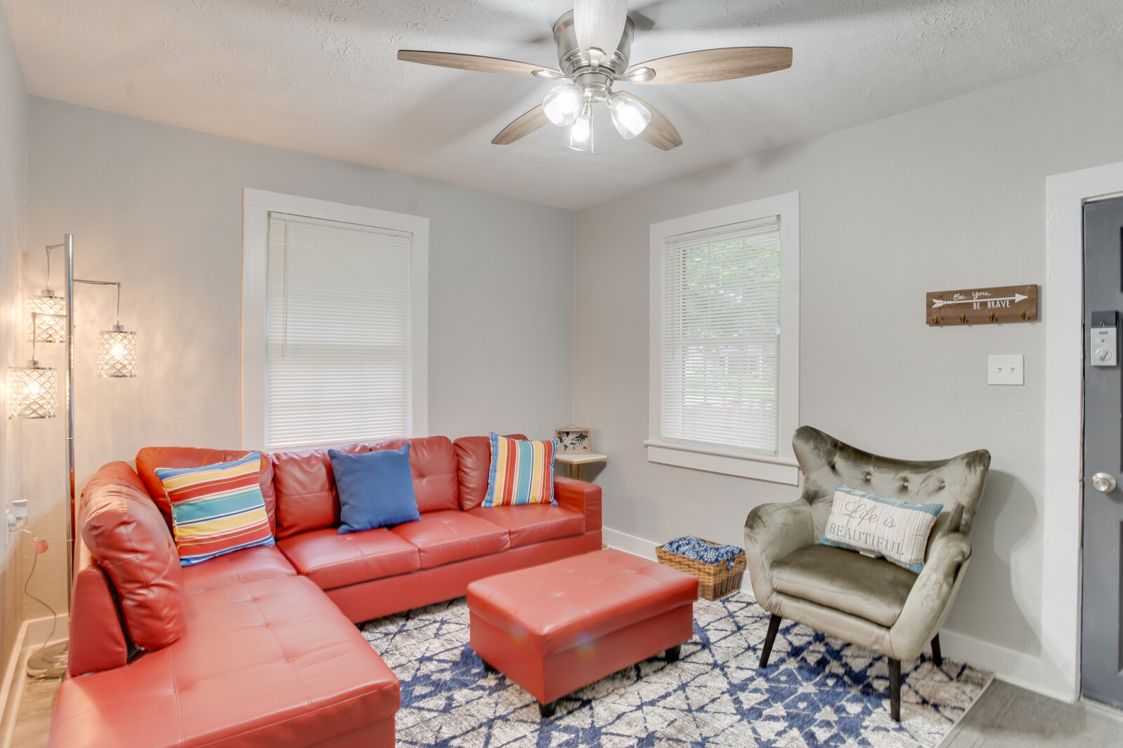 Bright and inviting living room with modern furniture and ceiling fan
