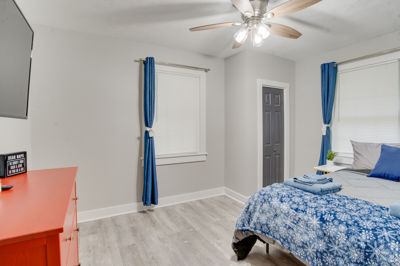 Spacious bedroom with blue-themed decor and natural lighting
