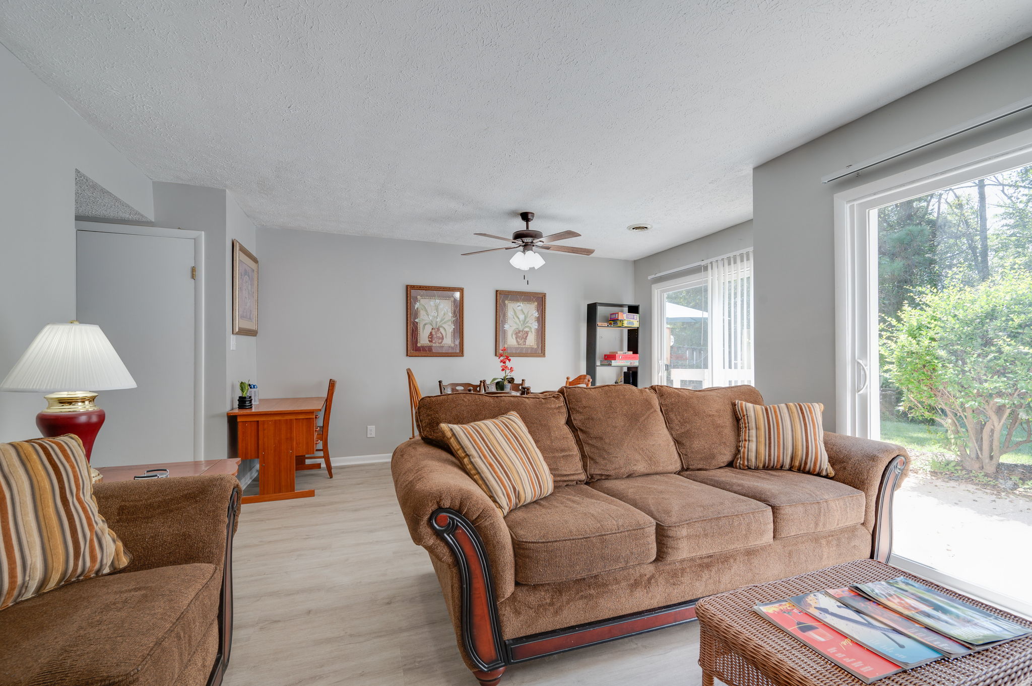 Bright and airy living room with brown sofa and large window view