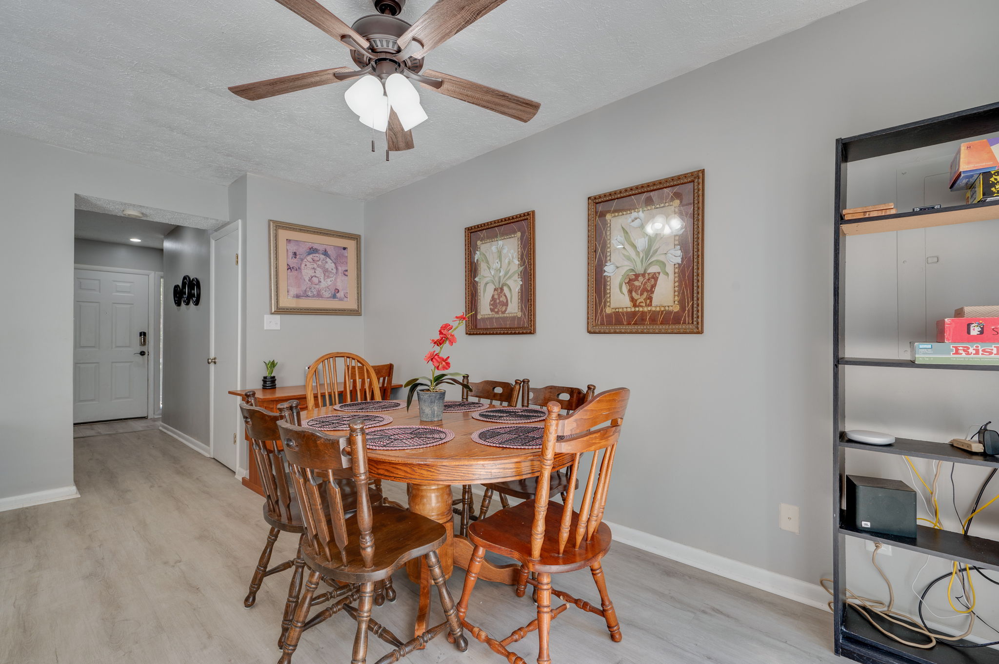 Elegant dining area with wooden table and framed artwork