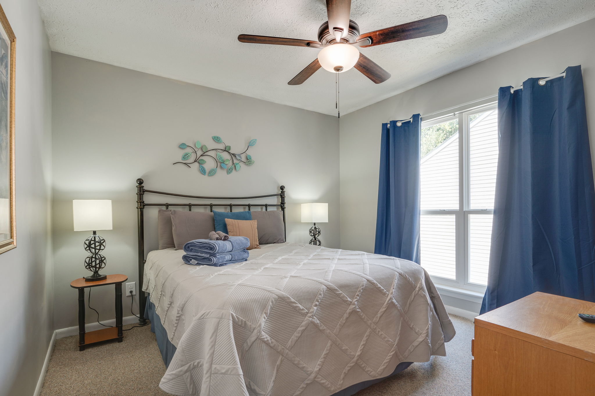 Master bedroom with stylish decor and ceiling fan