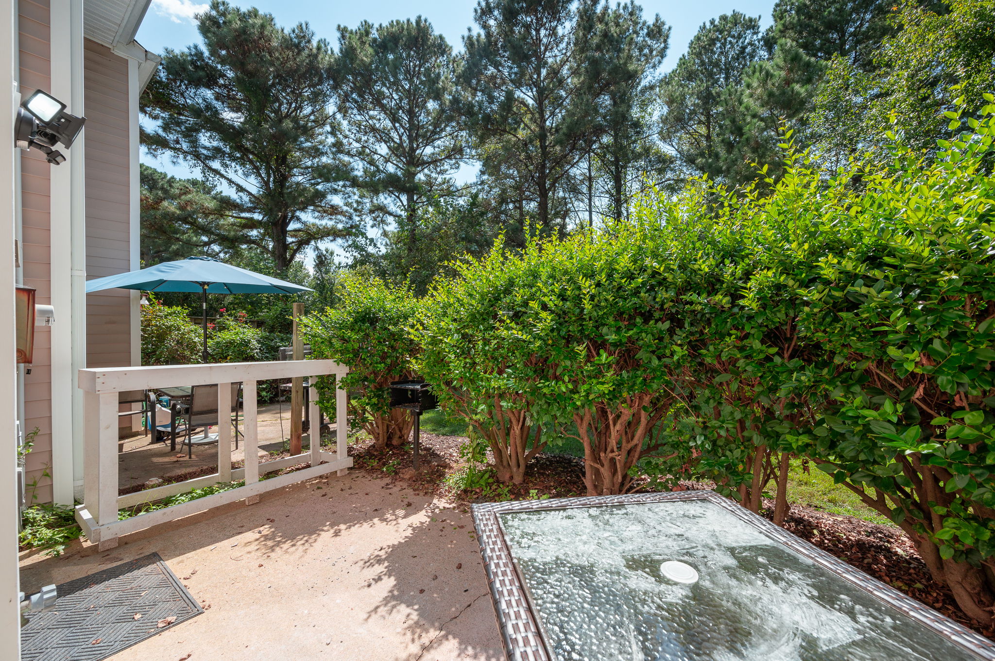 Outdoor patio with green landscaping and seating area