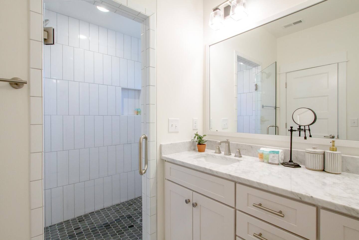 Elegant bathroom with a glass shower and marble countertops