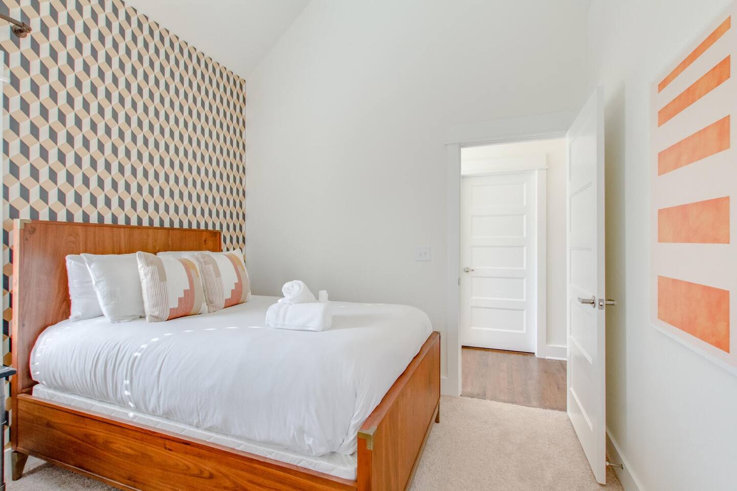 Modern bedroom with a bold accent wall and warm wooden furniture