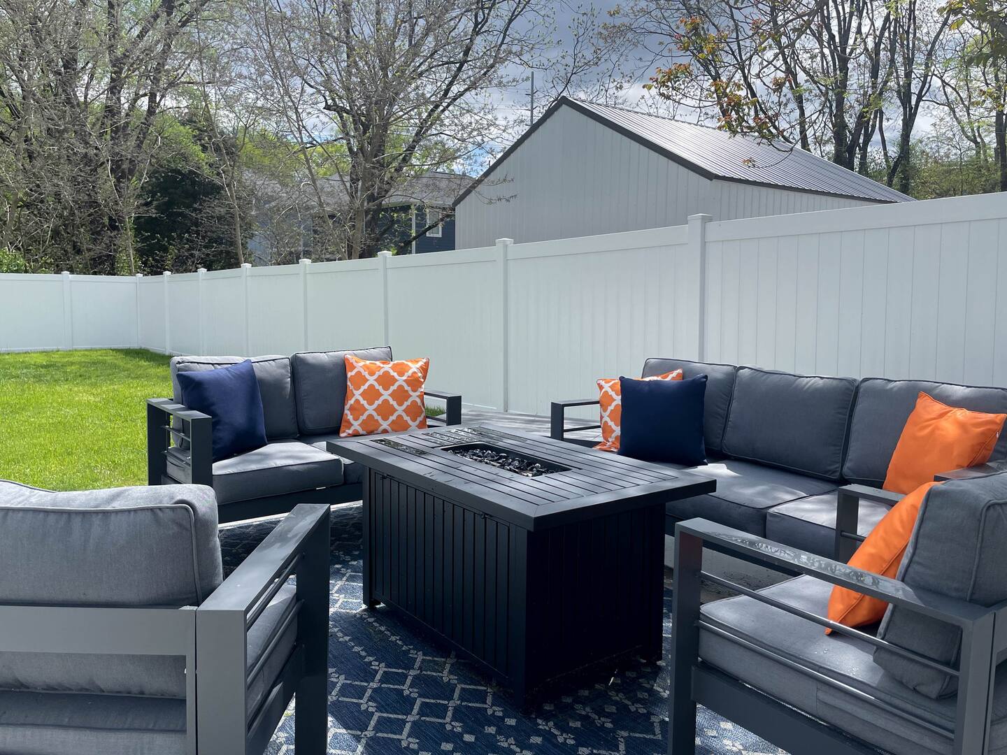 Outdoor patio with cozy seating and a fire pit