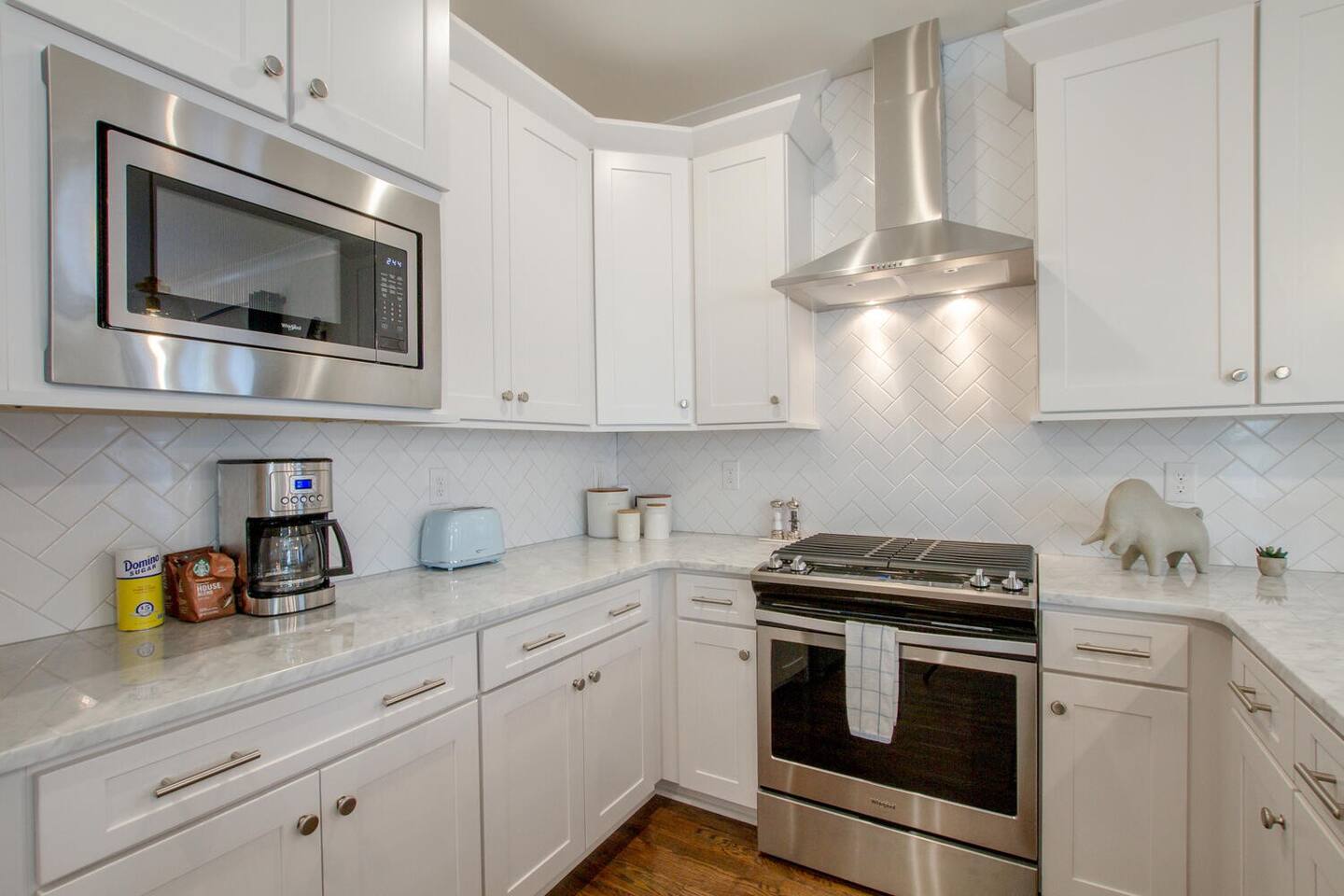 Sleek kitchen featuring a marble countertop and stainless steel appliances