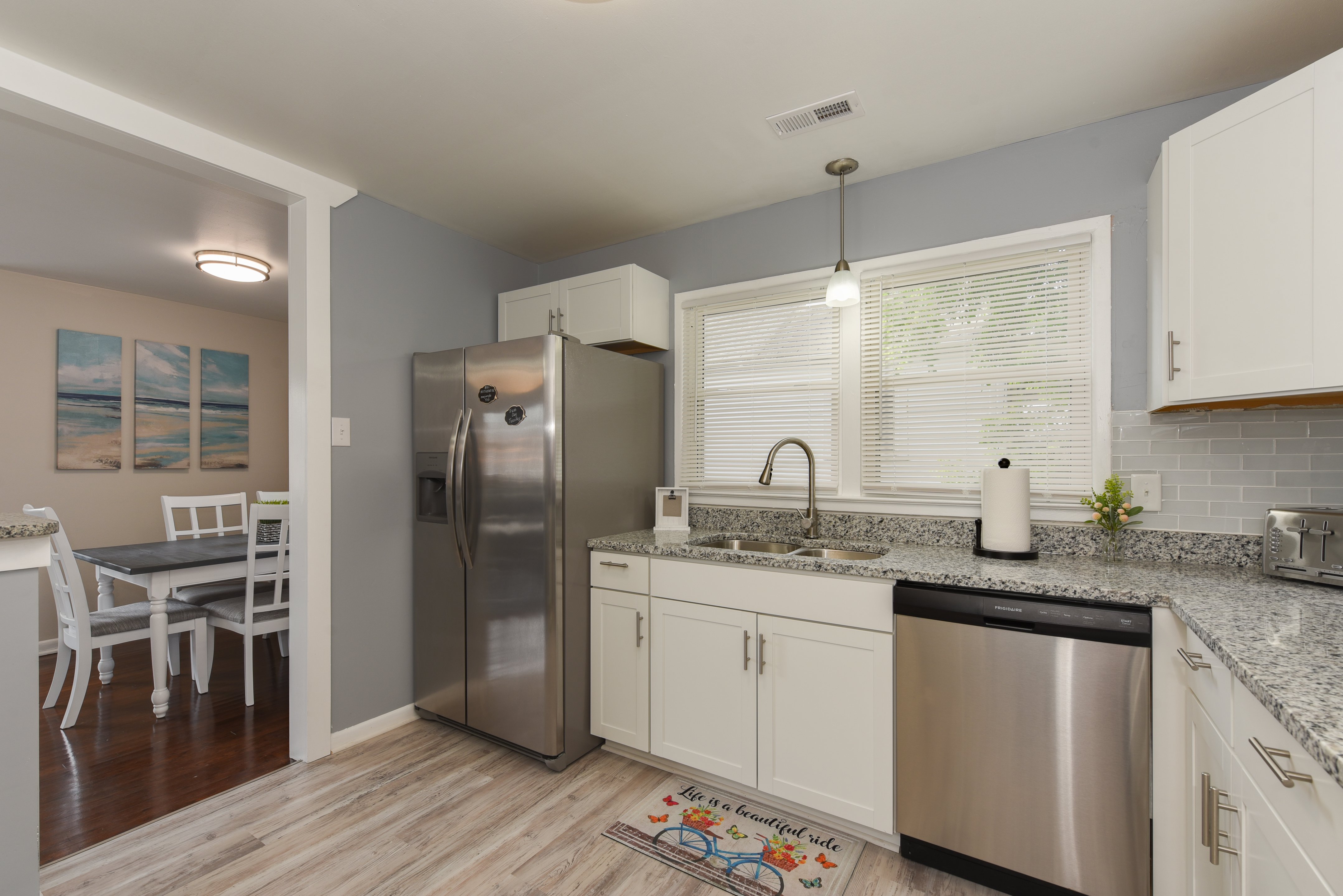 Kitchen view leading into the dining area with natural lighting
