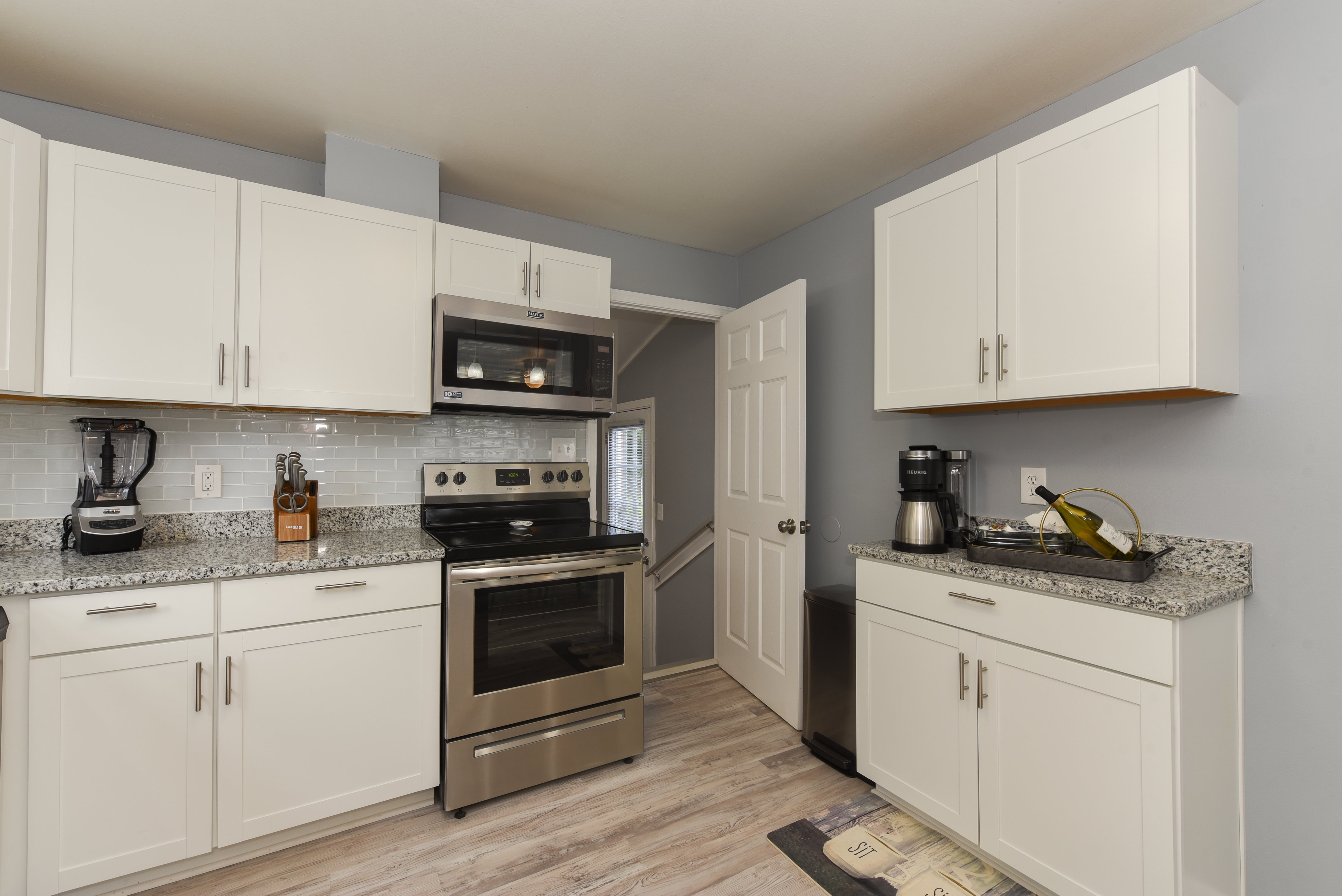 Kitchen with modern white cabinetry and stainless steel appliances