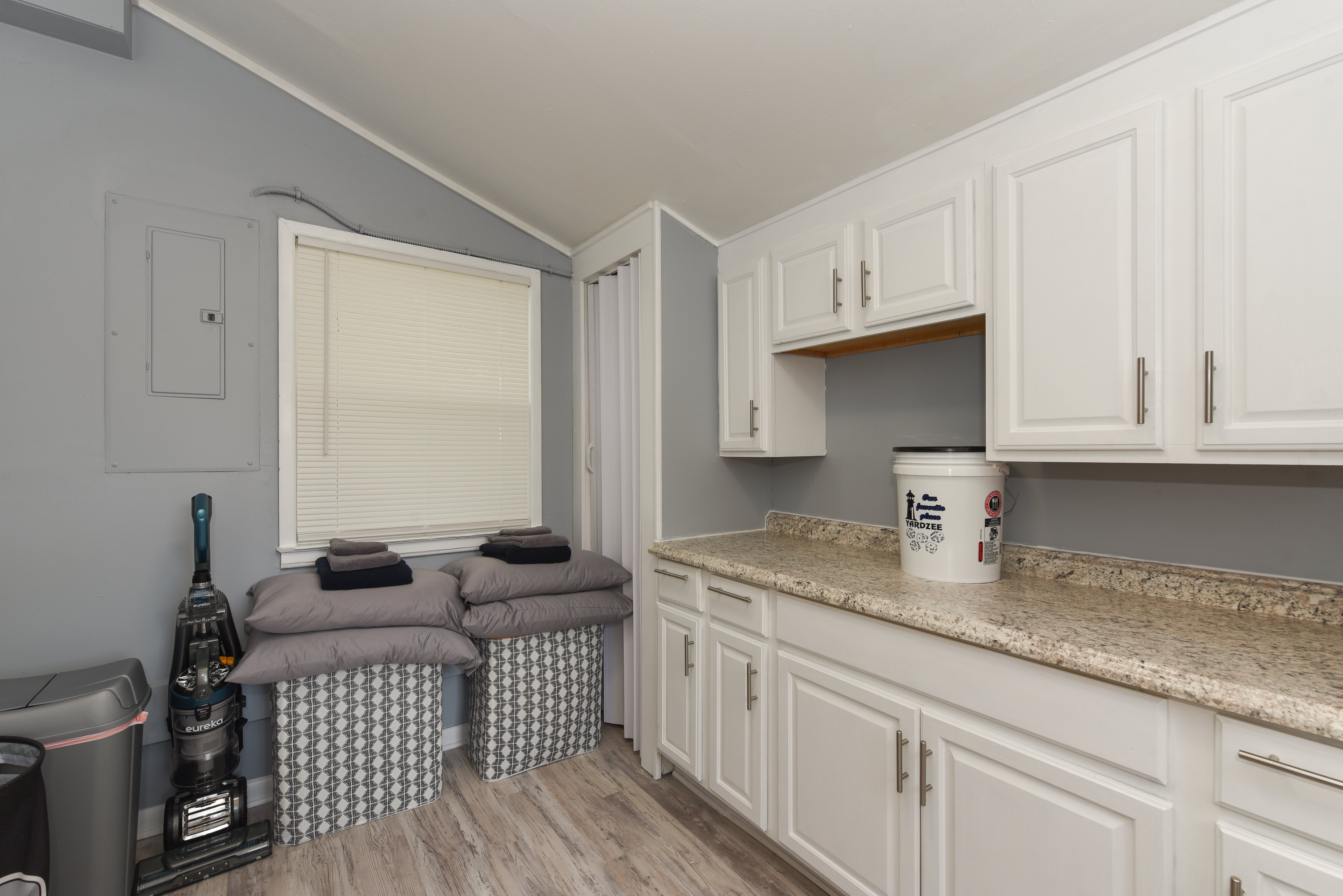 Additional storage space with cabinets and countertop in laundry room