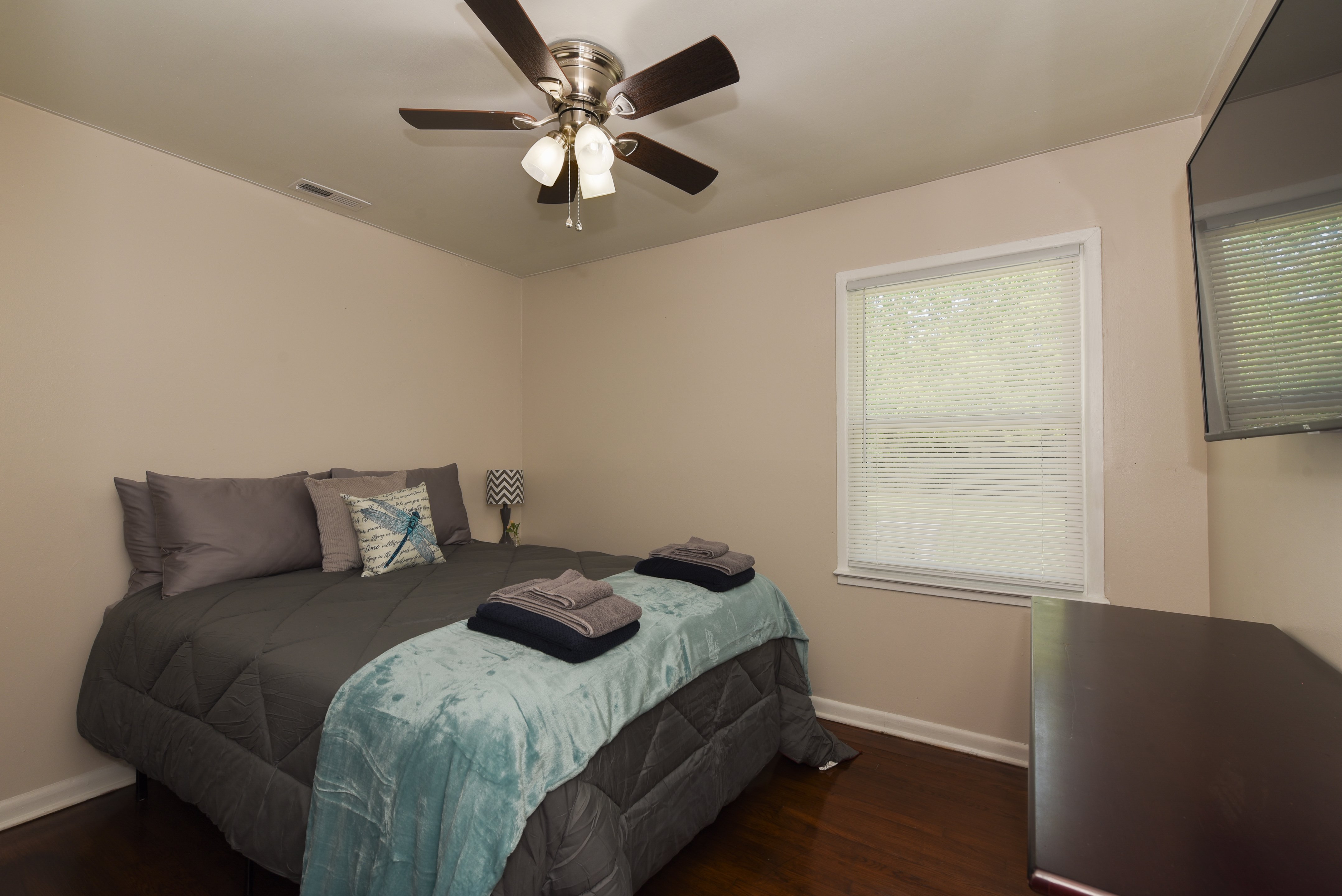 Comfortable guest bedroom with soft lighting and cozy bedding