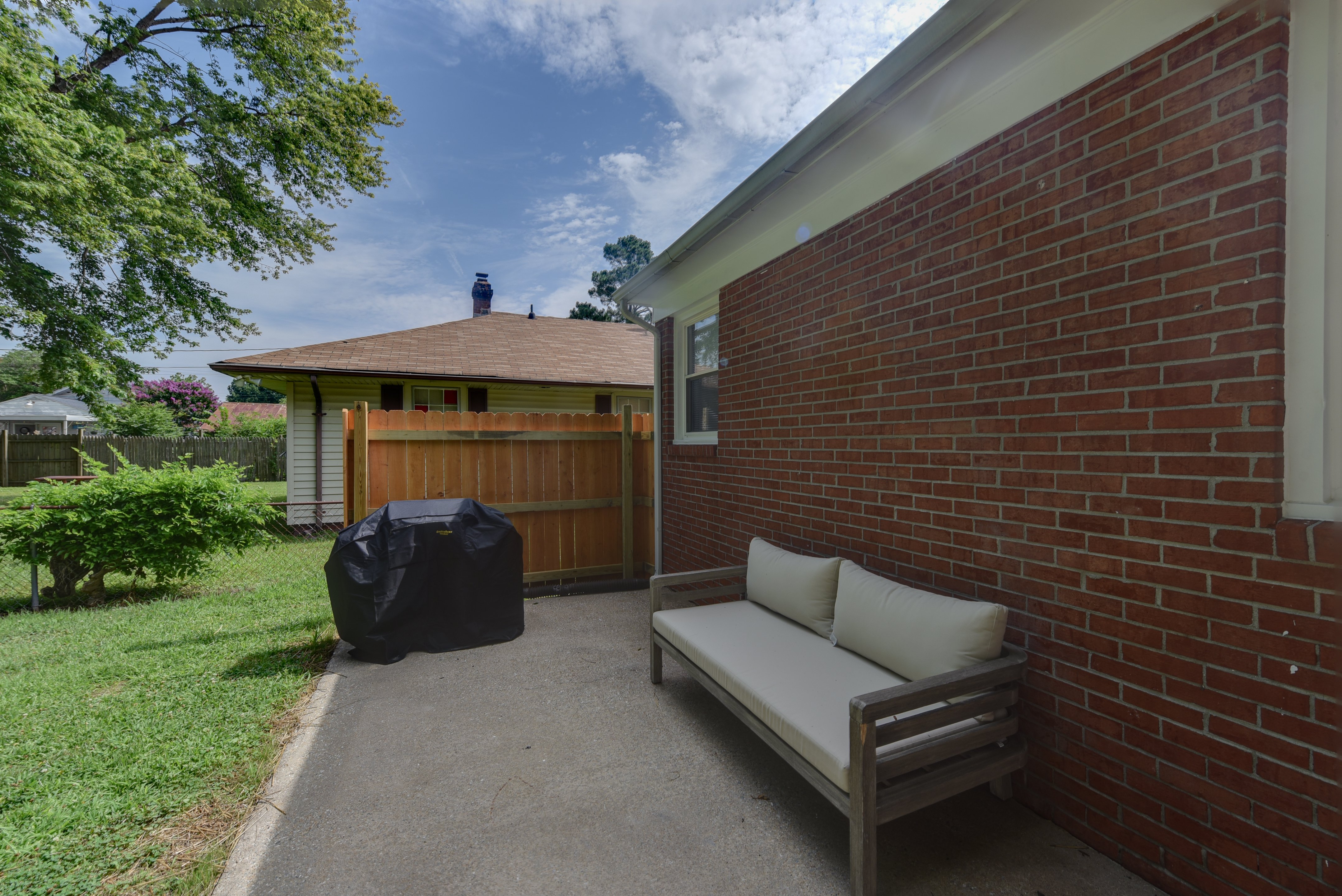 Outdoor patio area with a grill and seating space