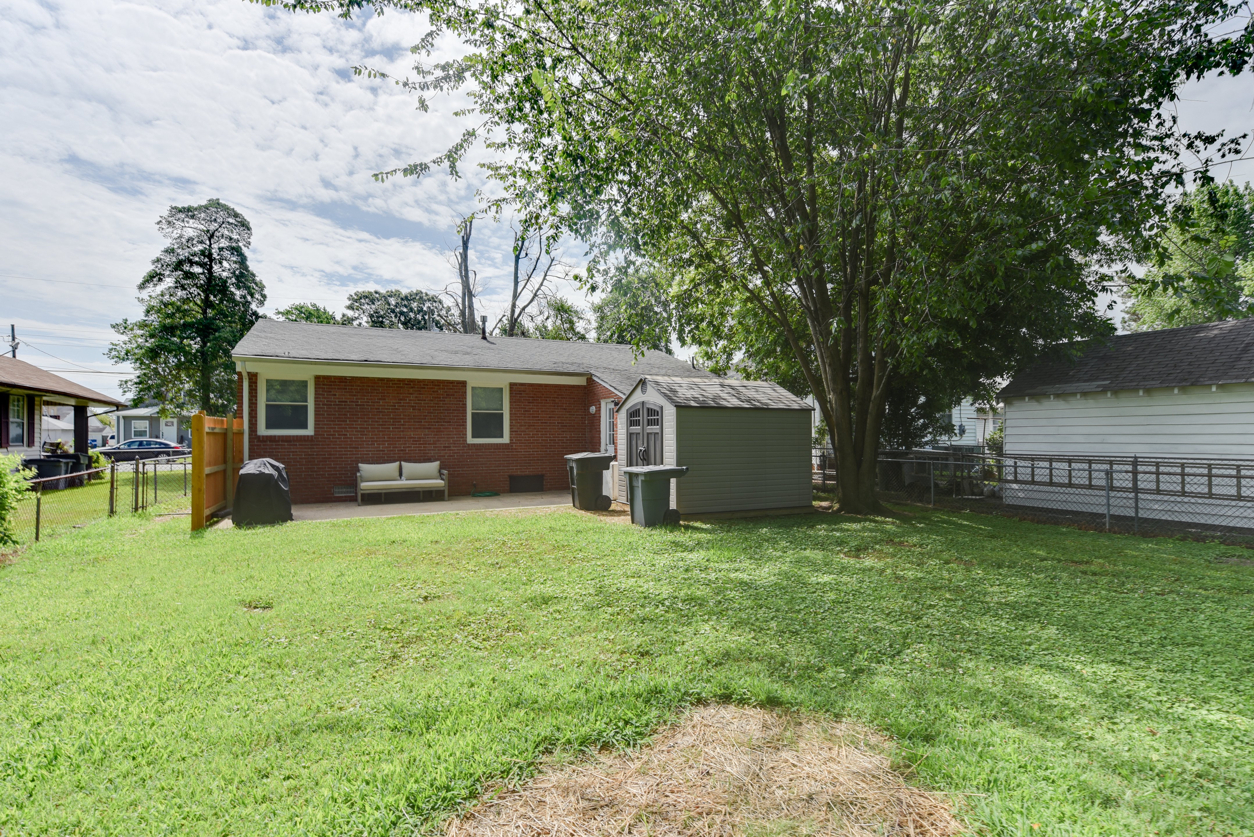 Spacious backyard with a storage shed and patio seating