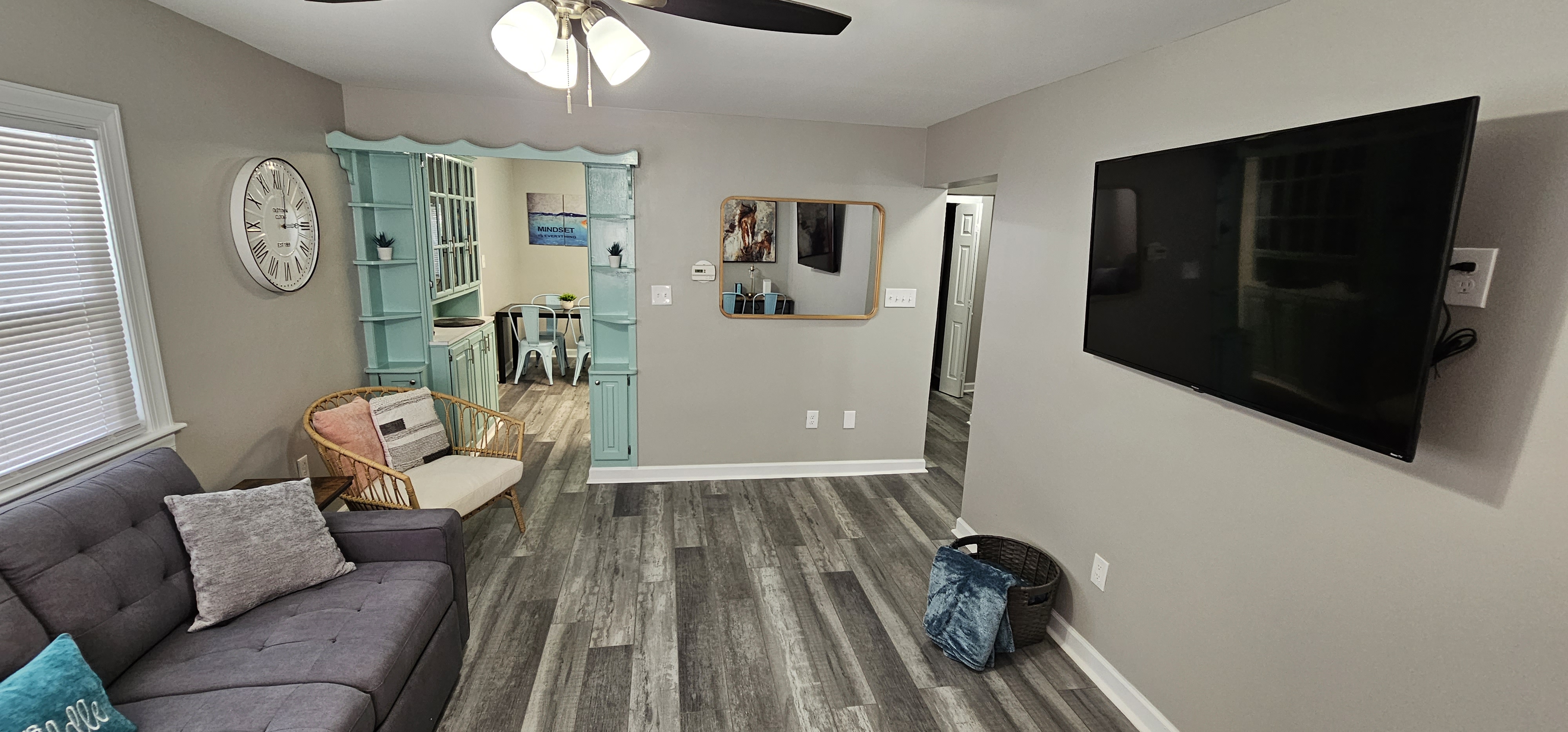 Open-concept living room with a mounted TV and a cozy seating area