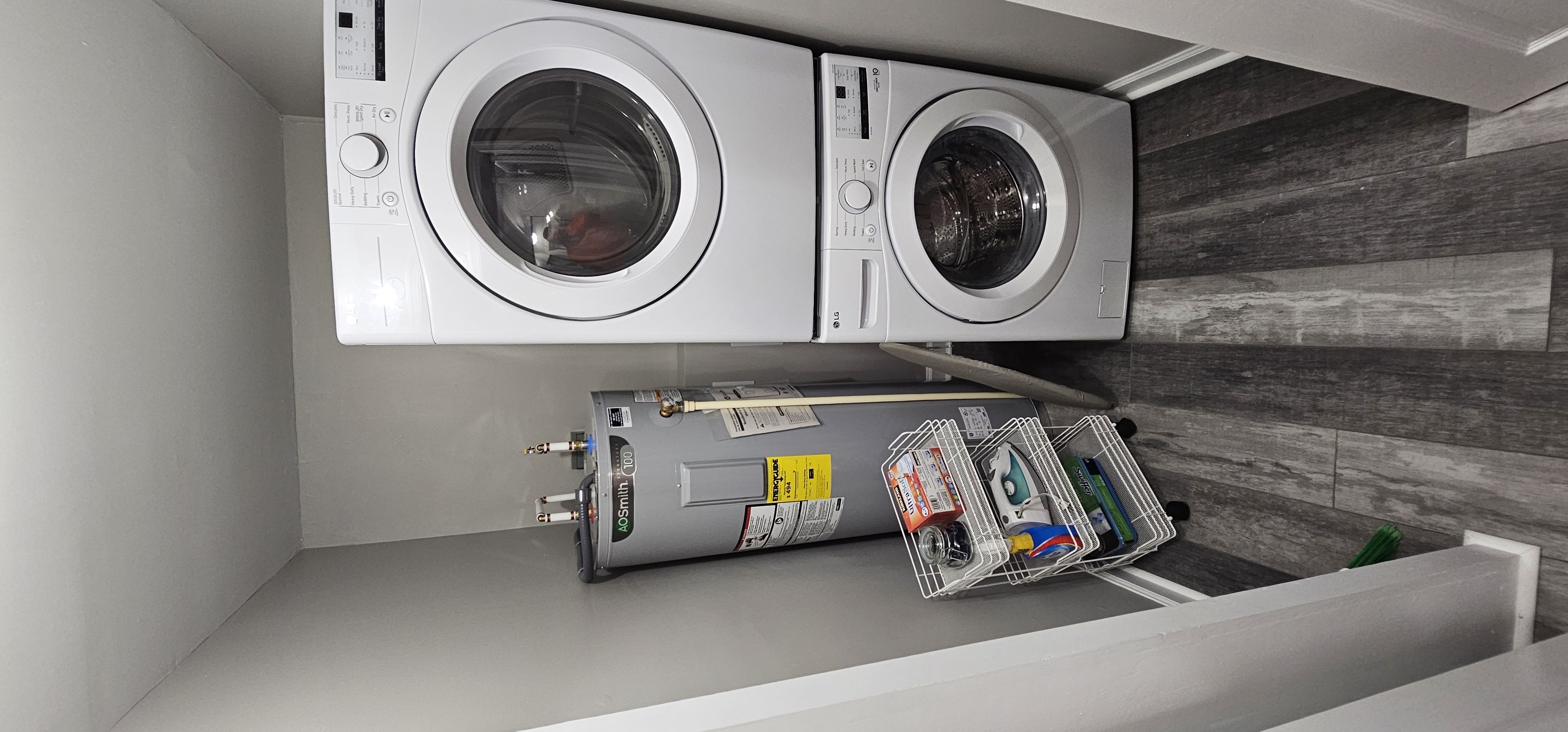 Laundry area with stacked washer and dryer unit