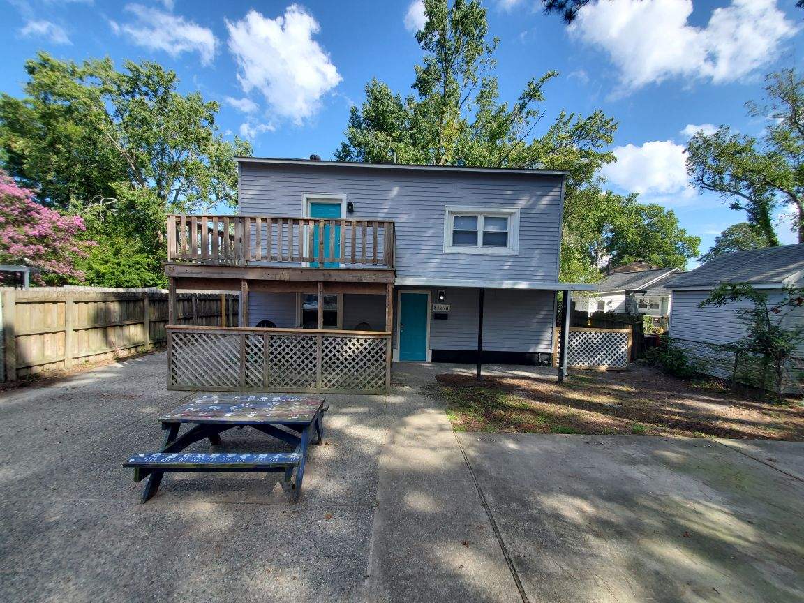 Two-story home with a spacious outdoor patio and picnic table