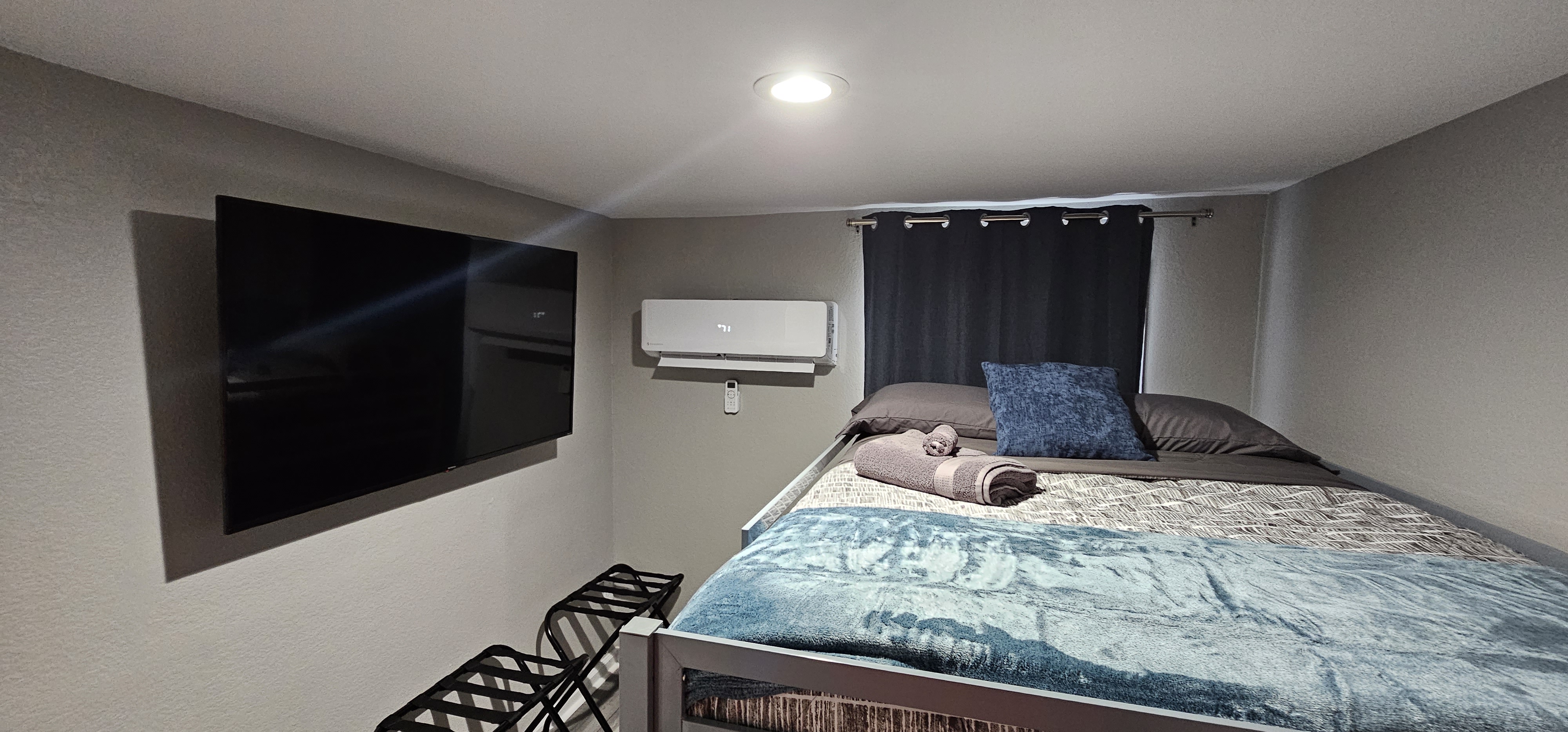 Close-up of a bunk bed with plush bedding and neatly folded towels.