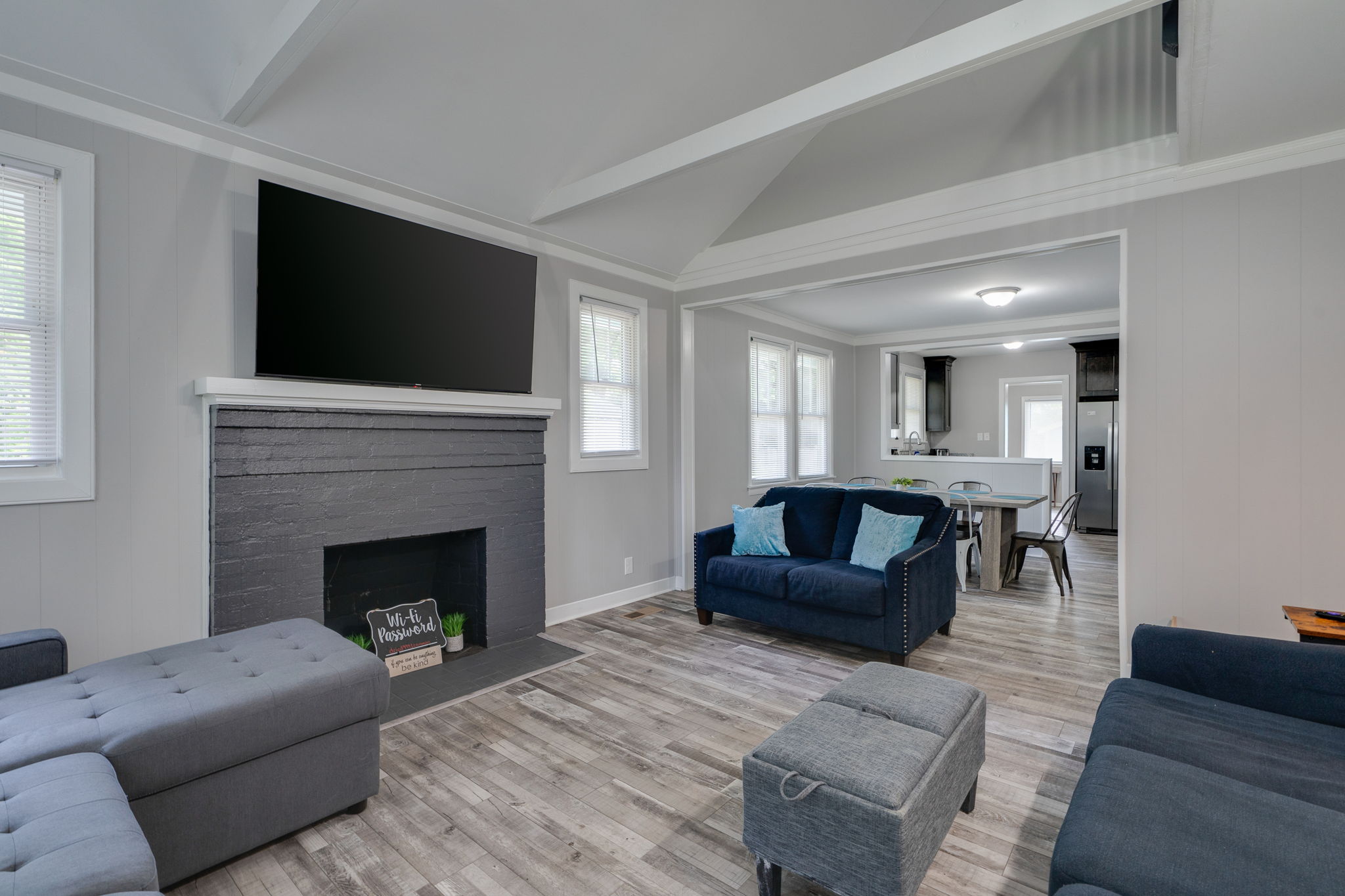 Stylish living room with a gray brick fireplace and vaulted ceilings.