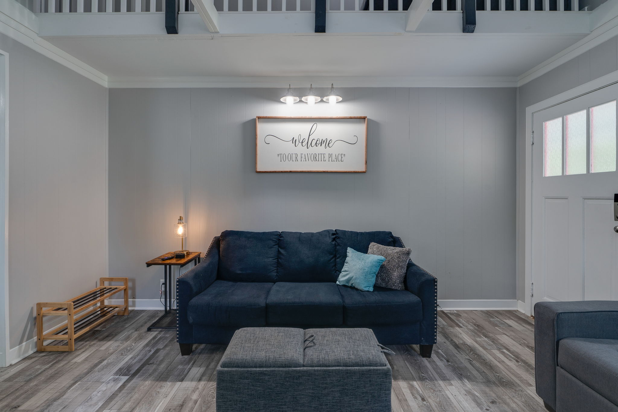 Cozy living space with navy blue sofas and modern decor.