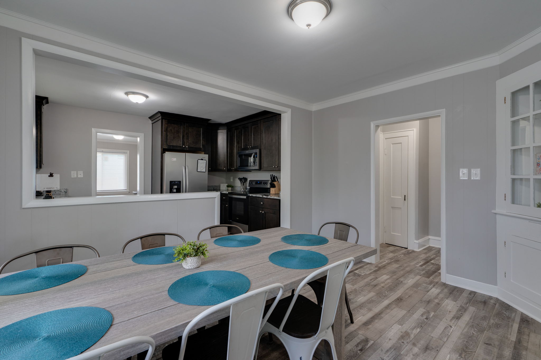 Open dining space with natural light and a view into the modern kitchen.