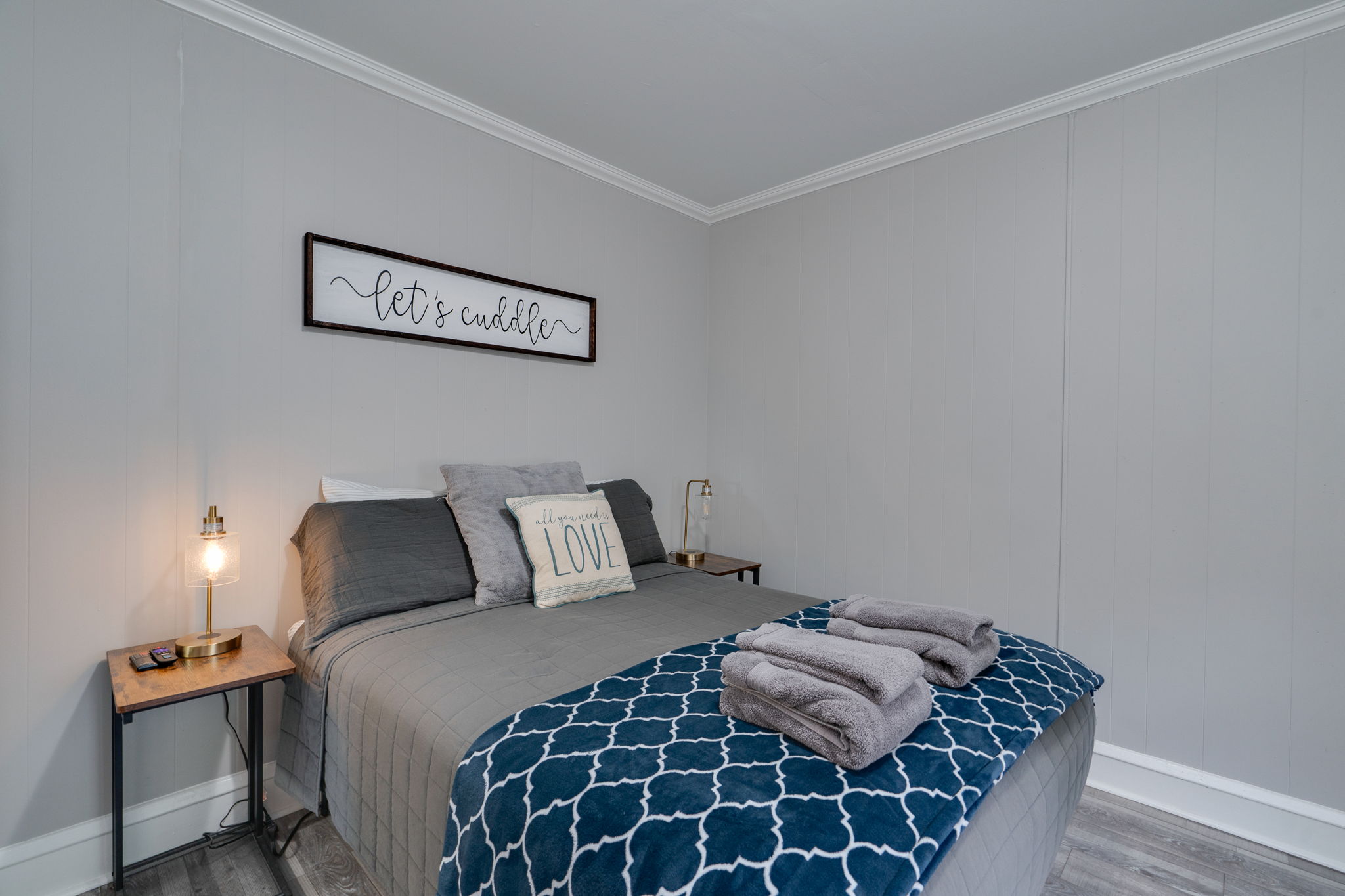 Warm and inviting bedroom with soft lighting, decorative pillows, and a plush blanket.