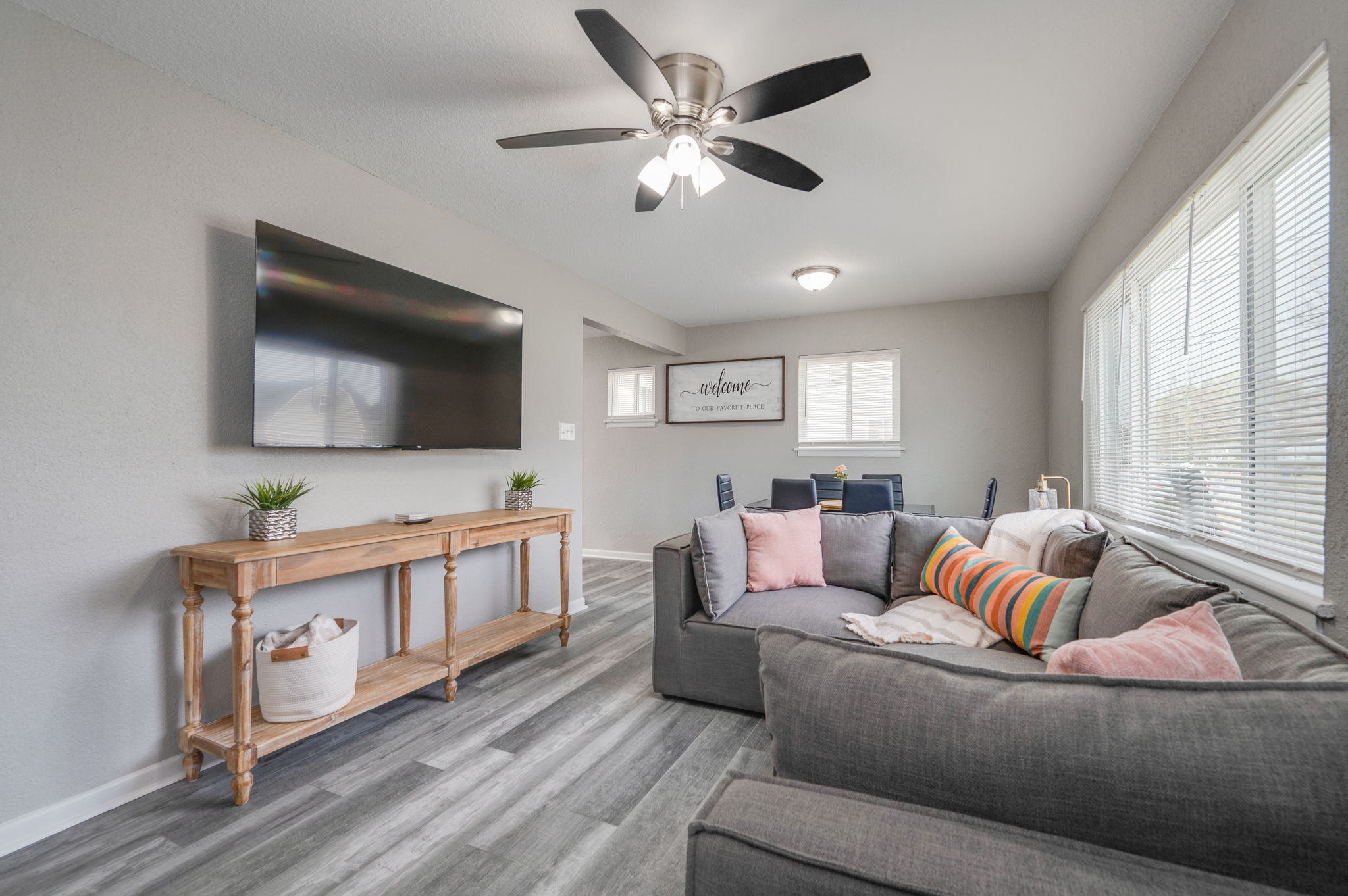 Modern living room with gray sectional sofa and wall-mounted TV