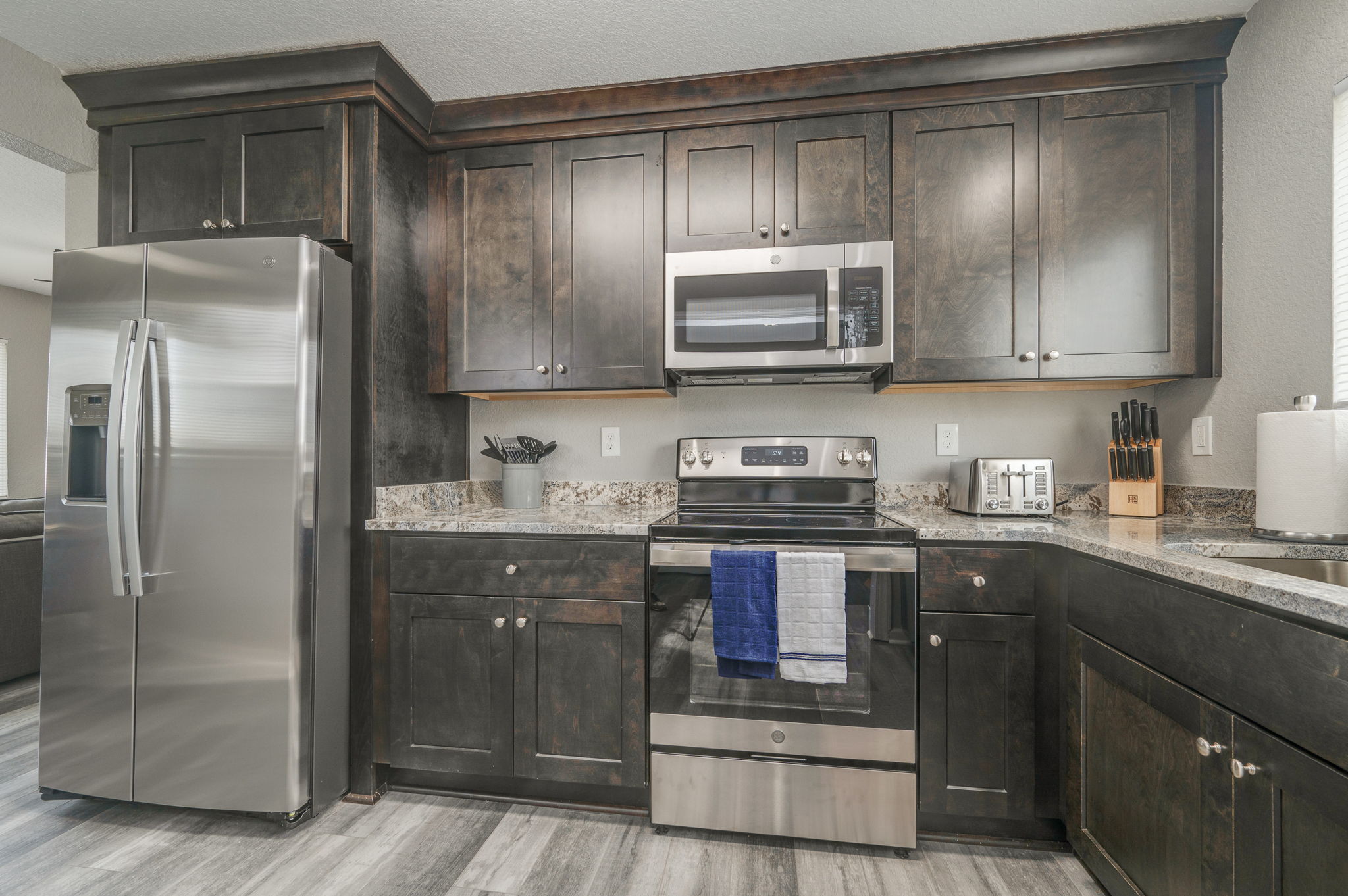 Fully equipped kitchen with granite countertops and dark cabinetry