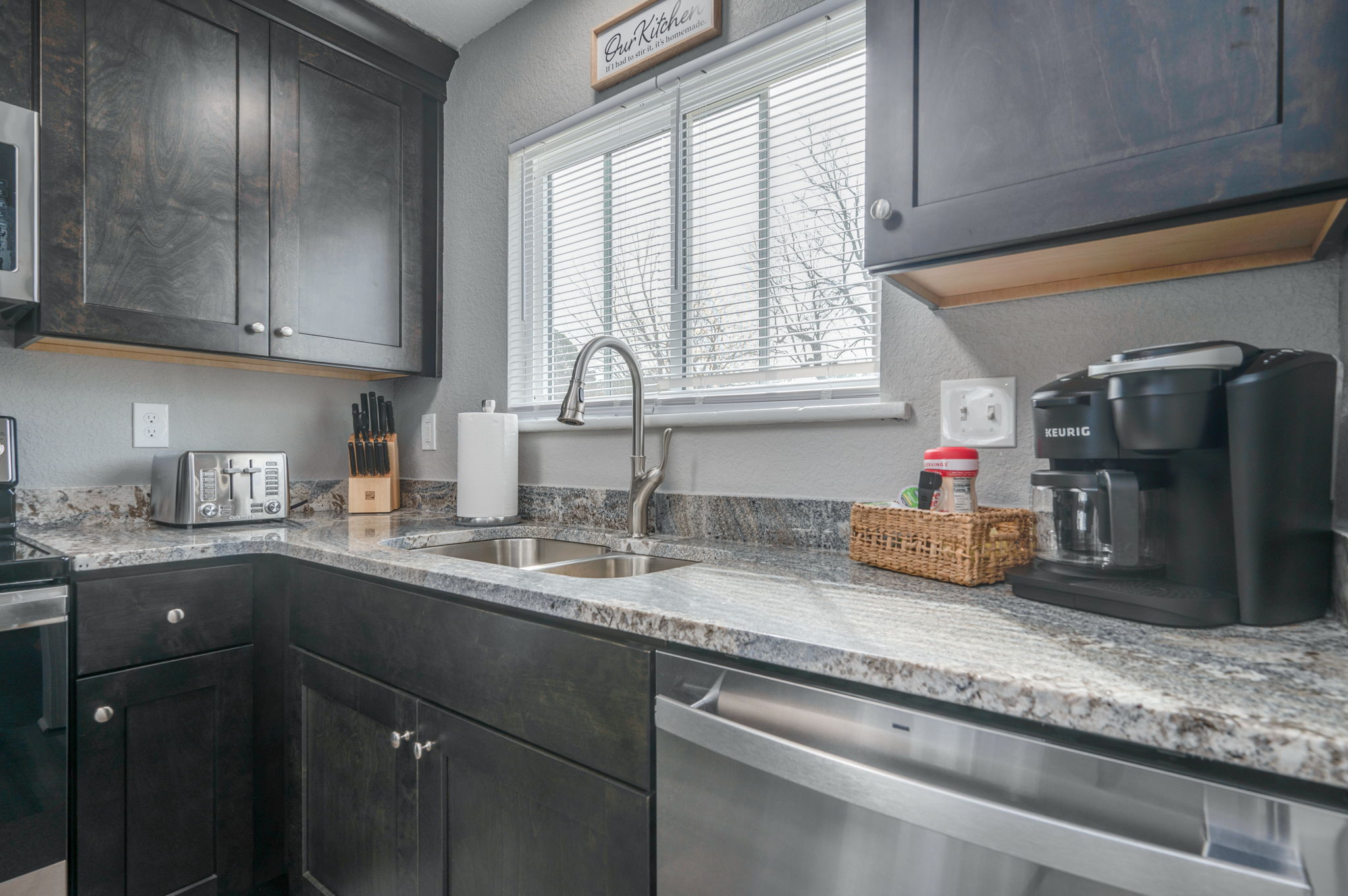 Sleek kitchen sink with stainless steel dishwasher and coffee maker