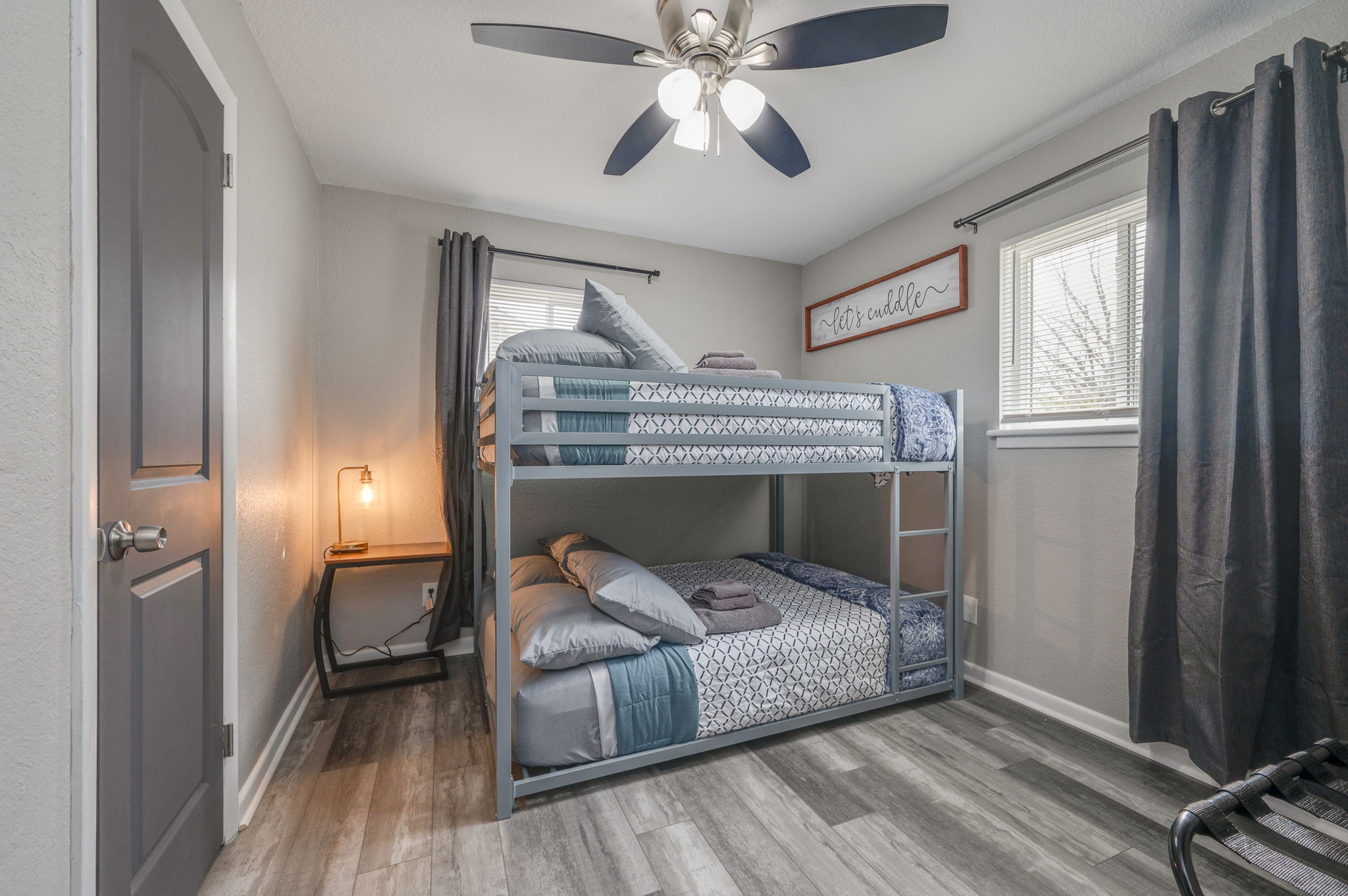 Stylish bunk bed bedroom with cozy bedding and soft lighting