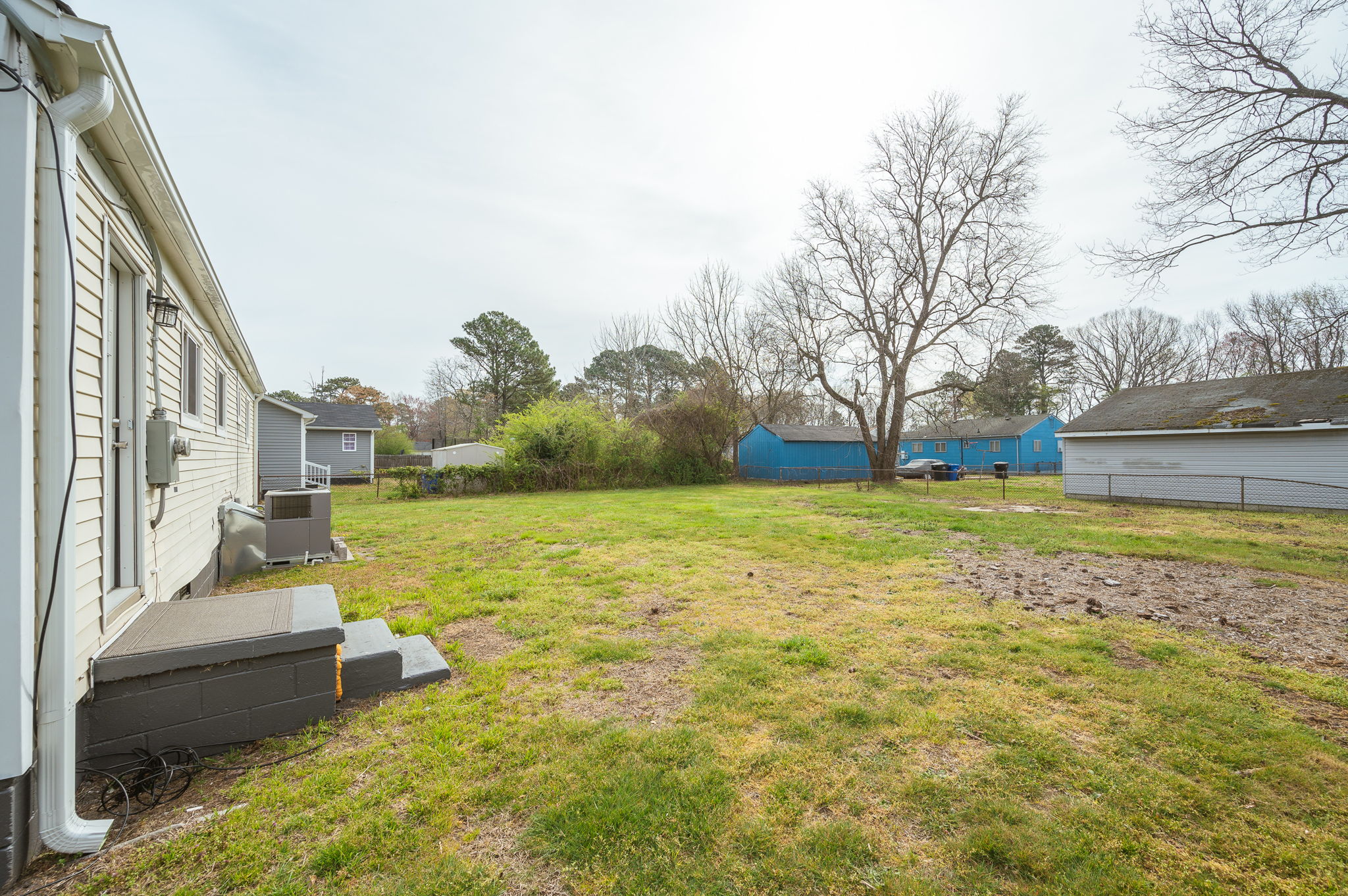 Large backyard with open space and mature trees