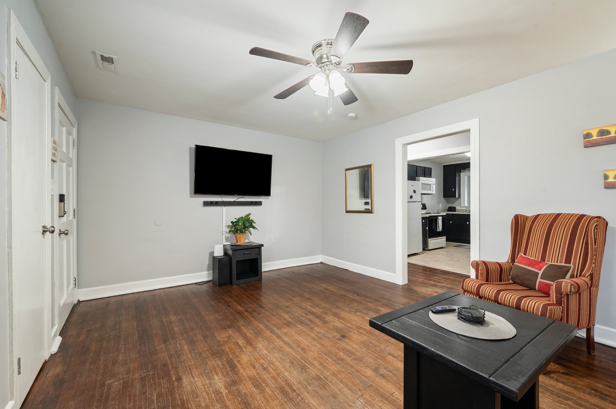 Living room with an open floor plan leading to the kitchen.