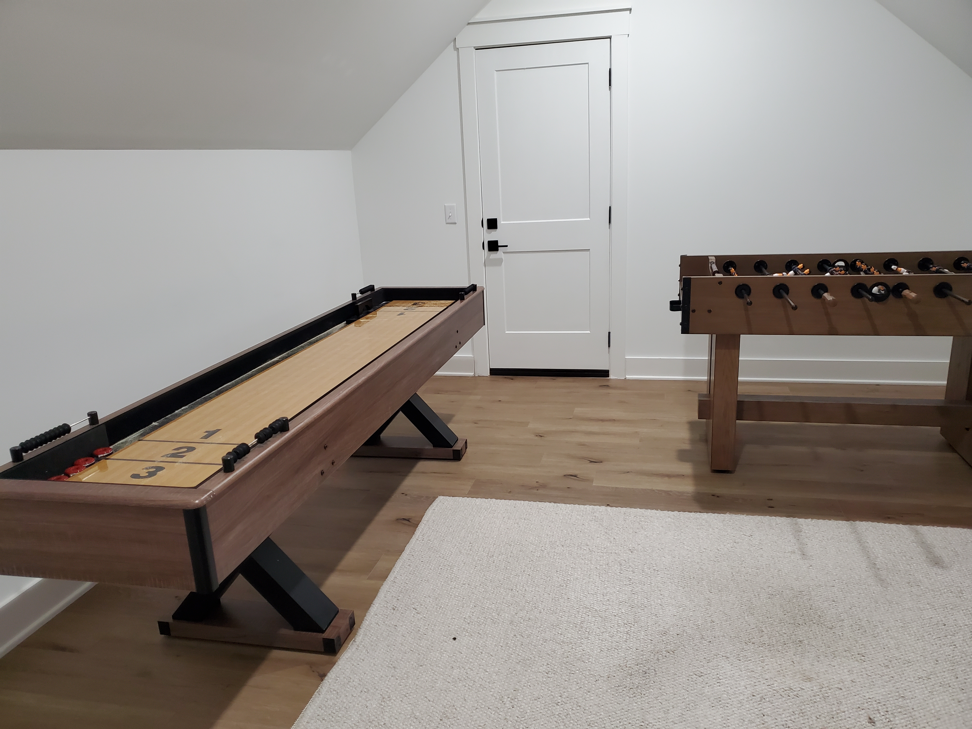 Game room with shuffleboard and foosball table