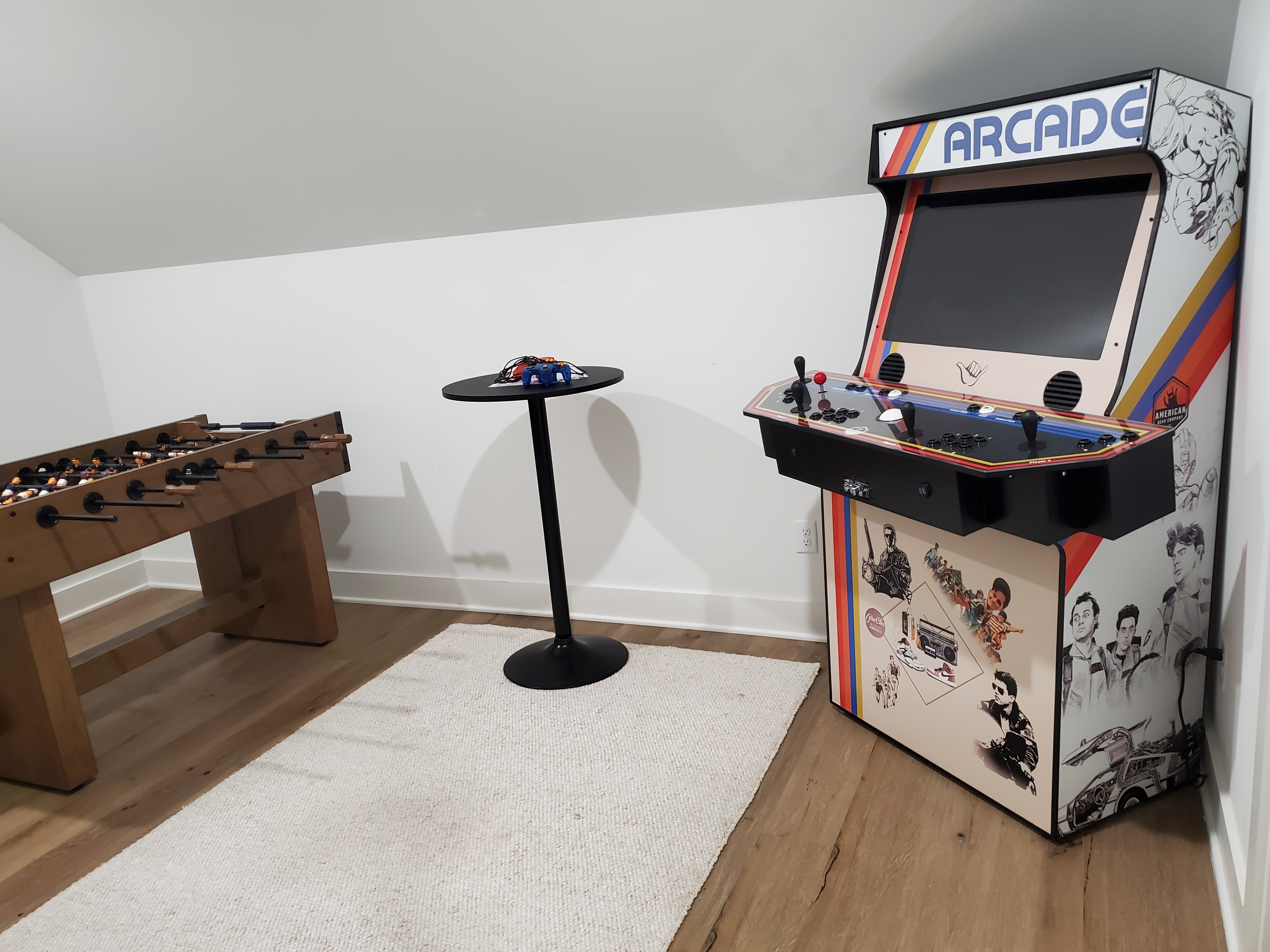 Entertainment space featuring arcade machine and foosball table